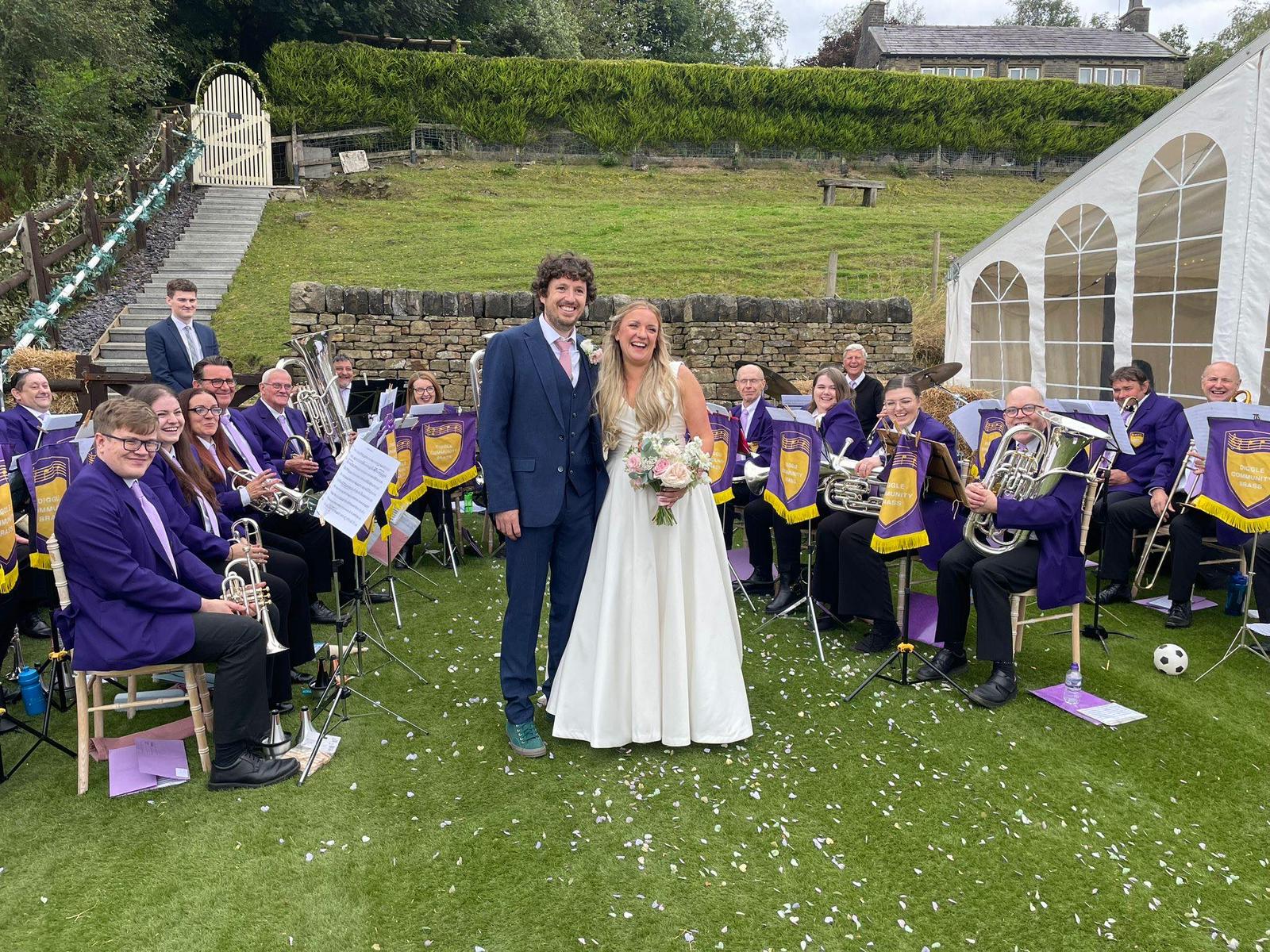 Picture of bride and groom with the band.